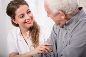 Picture,Of,Smiling,Nurse,Assisting,Senior,Man